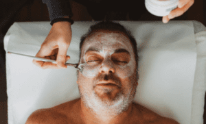Man relaxing during facial spa treatment
